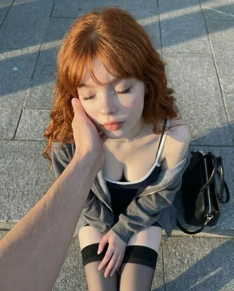 Adult AI character with auburn wavy hair